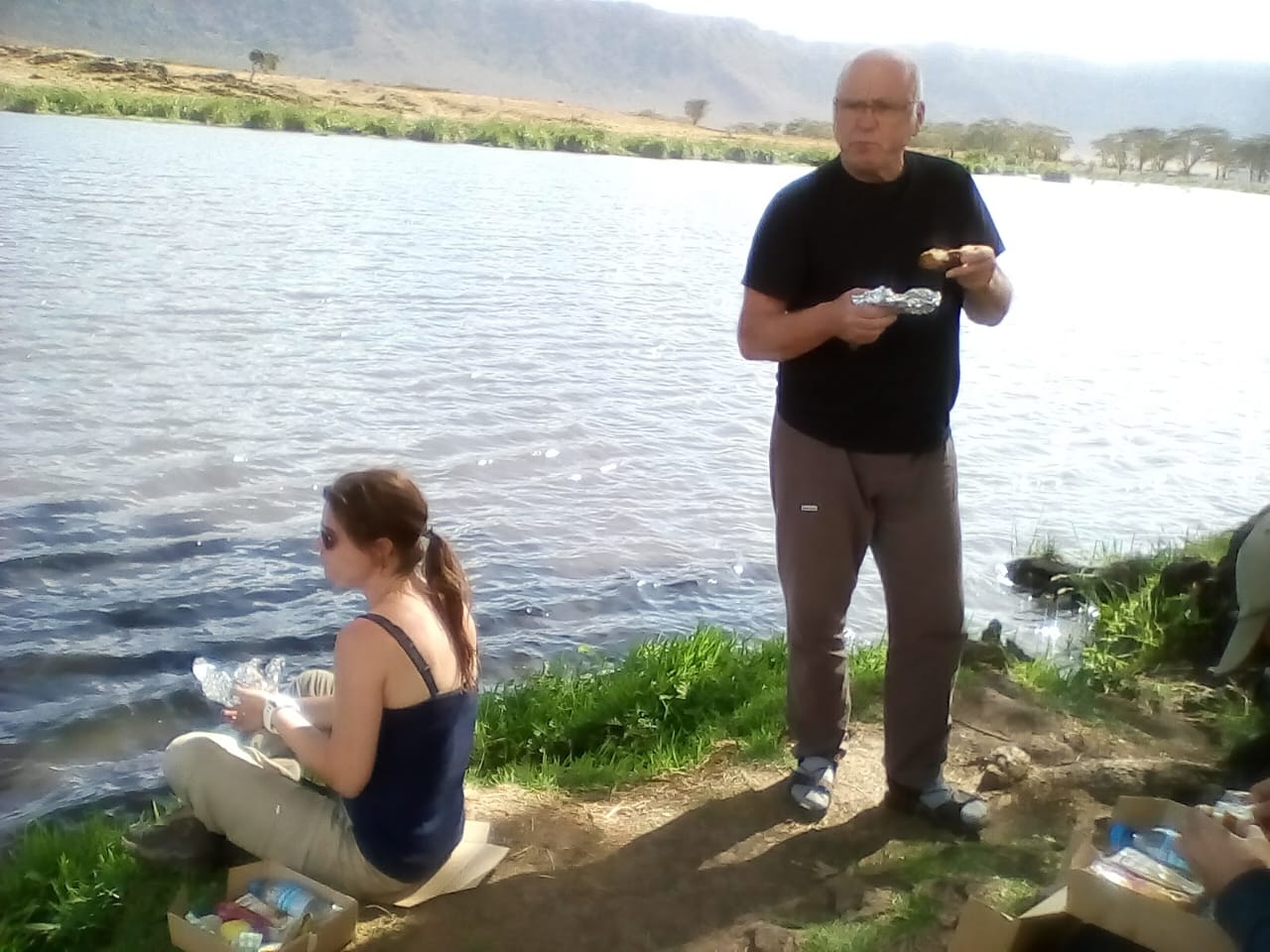 Olympus Adventure guests enjoying a bush picnic lunch beside a Ngorongoro crater lake